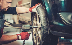 Mechanic at work on a car tire