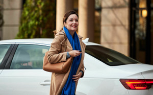 Lady looking into the distance after just getting out of her car