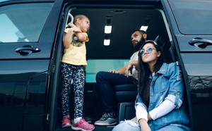 Family sitting in a van