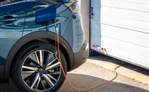 Blue SUV hybrid parked in front of house - Electric and hybrid car 