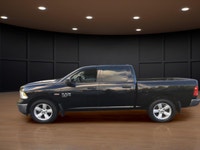 The 2022 Ram 1500 Classic SLT 4x4 Crew Cab in striking black is the perfect combination of power and... (image 1)