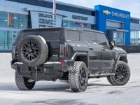 The 2024 GMC HUMMER EV SUV 2X commands attention with an electrified, wide-body stance that blends b... (image 5)
