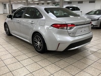 Dawn paints the streets in quiet silver as the 2021 Toyota Corolla L slips from the curb, its LED be... (image 3)