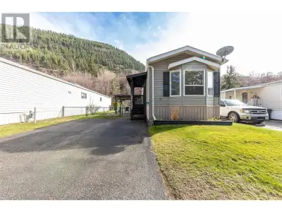 This 2008 mobile home offers one of the most stunning views of the iconic Red Pier on Little Shuswap...