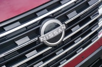 The 2025 Nissan Rogue Platinum, in striking Red, offers a sophisticated driving experience with only... (image 9)
