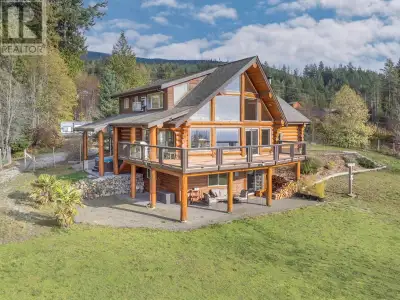 Welcome to this absolutely stunning hand-crafted log home that offers breathtaking panoramic ocean a...
