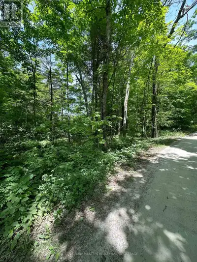 A beautiful treed lot across the lane from Bobs Lake, where you may gain glimpses of the lake in lat...