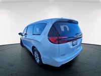 The 2024 Chrysler Pacifica Touring-L FWD, dressed in a pristine white finish, offers a smooth and co... (image 6)