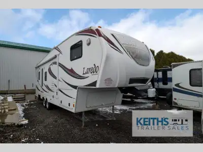 Double Slide Laredo Fifth Wheel by Keystone w/Rear Living Area Including 2 Lounge Chairs, Corner TV,...