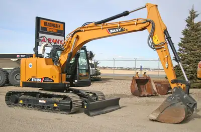 The SY155U shown here is equipped with a Wedge Style Quick Coupler. Front Knock Down Blades are stan...
