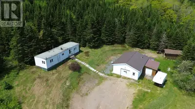 Looking for the ultimate garage setup with a place to live? This private 2.7 acre property is exactl...