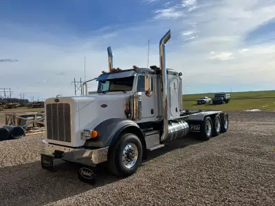 Peterbilt 367 Tri drive LOW KMS Truck was lightly rolled on driver side, truck has a salvage title T...