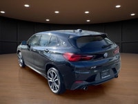 The 2022 BMW X2 xDrive28i Sports Activity Coupe in a sophisticated black finish and equipped with BM... (image 5)