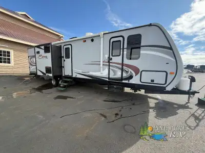 The triple slide Spree 329IK travel trailer by KZ offers a bunk house and an outside kitchen.As you...