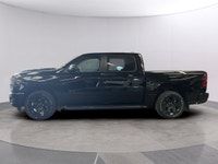The 2026 Ram 1500 Express 4x4 Crew Cab 57 Box is a powerful yet stylish black truck thats ready for... (image 1)