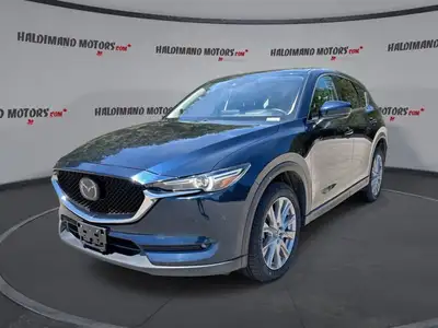 Finished in blue with a black interior, this used 2021 Mazda CX-5 GT AWD brings together upscale com...