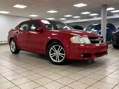 A red 2011 Dodge Avenger SXT easing through the day has a way of making routine driving feel more de...