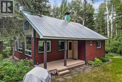 Located in Lac des Arcs, this charming cabin sits on an expansive 19,000+ sq. ft. lot with mature tr...