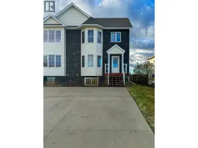 Half duplex in Panorama Ridge featuring an open main floor layout with a nice living area, bay windo...