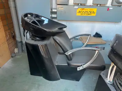 2 black hair salon chairs
