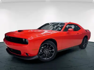 Meet the 2022 Dodge Challenger GT in a vibrant orange finish, gracefully combined with an AWD drivet...