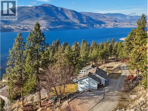 Elevated Lake Living with Income Potential! Perched above Skaha Lake on a peaceful no thru road, thi...