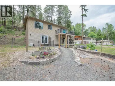 Nestled among the trees with partial lake views and exceptional privacy, this charming 4-bedroom, 3-...