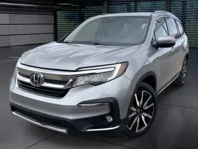 The 2021 Honda Pilot Touring 8-Passenger AWD in Silver is an exceptional choice for those seeking a...