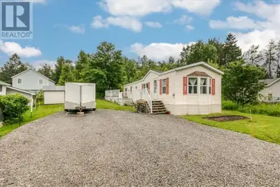 Welcome to this beautifully maintained 2-bedroom modular home, perfectly situated on a stunning, lan...