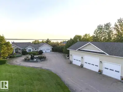 Lakefront Masterpiece of Design. Extensively modernized & expanded, this bungalow in Chateau Estates...