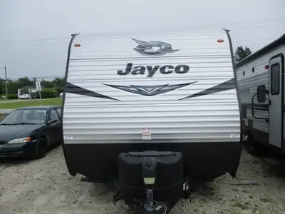 A towable family unit with a front queen bed, one rear side double bunk , rear corner bath w/ skylig...