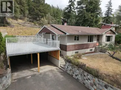 Enjoy privacy and space on this treed 4.5-acre property with southern exposure and peek-a-boo lake v...
