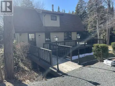 Welcome to your private retreat! This two story chalet style home sitting sheltered amongst mature t...