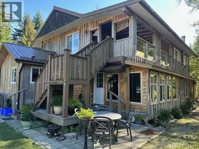 1/4 interest in a stunning waterfront four-plex on a generous, sun-soaked beach by pristine lake wat...
