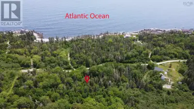 Create your perfect coastal getaway on this charming 1.6-acre wooded lot, just a short stroll from t...