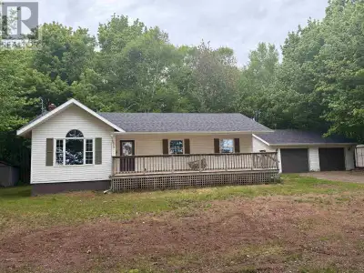 Nestled among the trees and offering plenty of privacy, this 3-bedroom, 1-bath bungalow presence an...