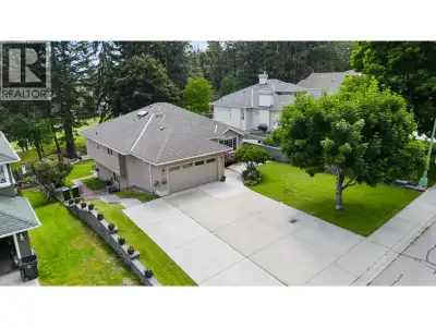 GOLF COURSE OASIS WITH LEGAL SUITE! Discover an exceptional retreat at 2211 Shannon Woods Place. Nes...