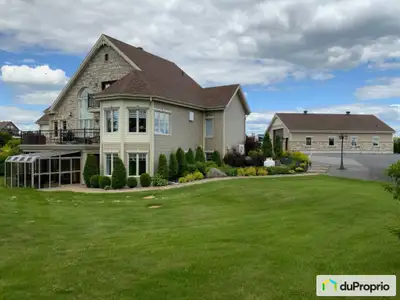Vue sur la rivière Saguenay avec accès par le terrain. Rez-de-jardin avec verrière extérieure pour l...
