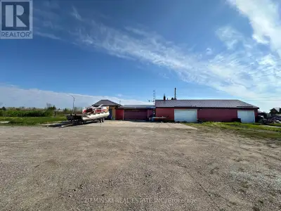 This 0.9-acre lot offers potential for commercial or residential use and includes a spacious four-ba...