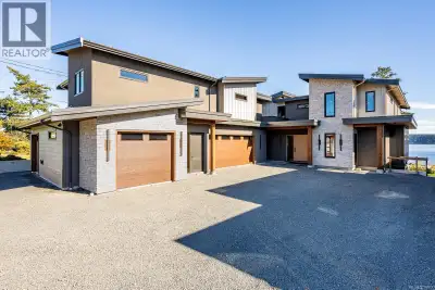 Overlooking the ever changing waters of Discovery Passage, this 8400 sq ft coastal residence on a ra...