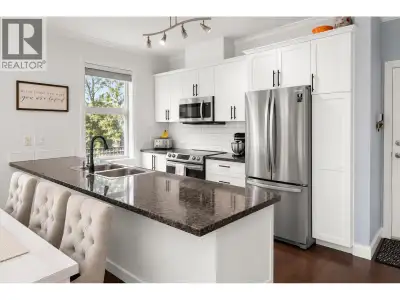 Impeccably maintained PENTHOUSE showcasing 11' ceilings in the living room and extra windows on the...