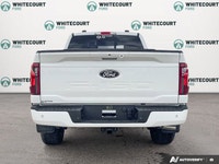 The 2026 Ford F-150 XLT, dressed in a striking Oxford White finish, showcases a commanding 4x4 drive... (image 5)