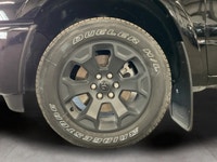 The 2026 Ram 1500 Big Horn 4x4 Crew Cab in a striking black exterior combines rugged durability with... (image 8)