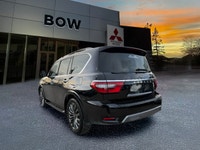 The 2023 Nissan Armada 4x4 Platinum in a striking black finish is a powerhouse SUV designed for both... (image 5)