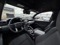 The SR5 focuses on utility and versatility, offering a standard three-row configuration and a part-t... (image 6)