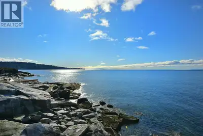 Spectacular low-bank waterfront property with main residence + 3 separate guest cottages, offering a...