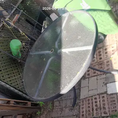 Round patio table - plastic/glass top with metal frame. Approximately 4 ft in diameter Free to pick...