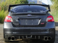 Feel the thrill of the road with the 2017 Subaru WRX STI Sport, finished in a striking shade of gray... (image 3)