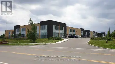 Modern bright commercial/industrial condo unit with front glass drive in ground shipping door, alumi...