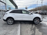 The 2026 Cadillac XT5 Sport AWD, finished in Crystal White Tricoat with a rich Kona Brown interior w... (image 9)